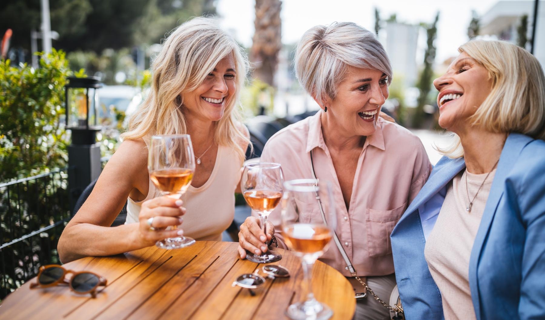 a group of women holding glasses of wine