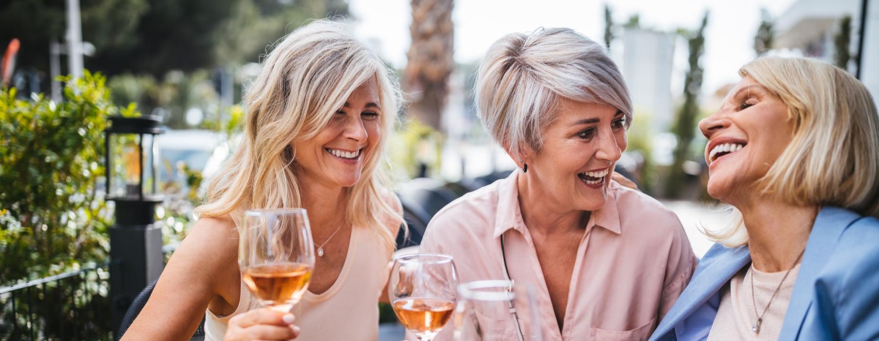 a group of women holding glasses of wine