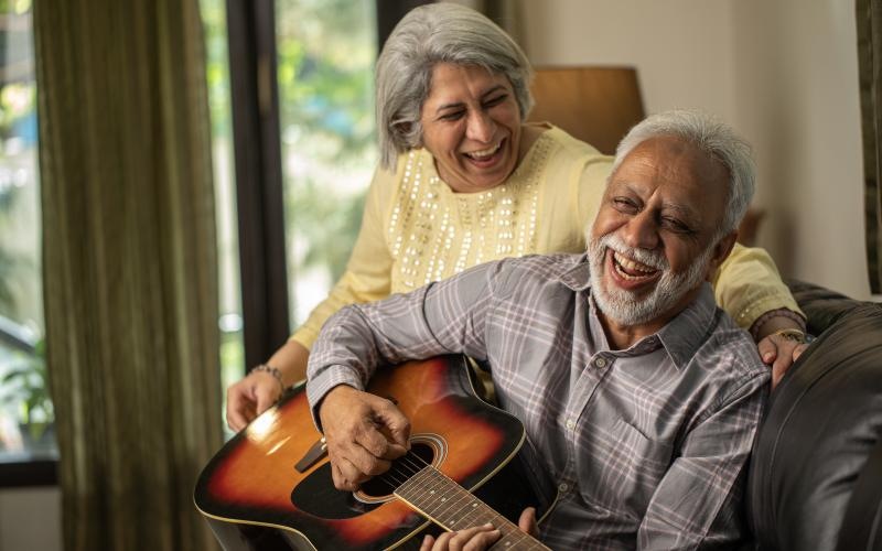 a man and woman playing guitar