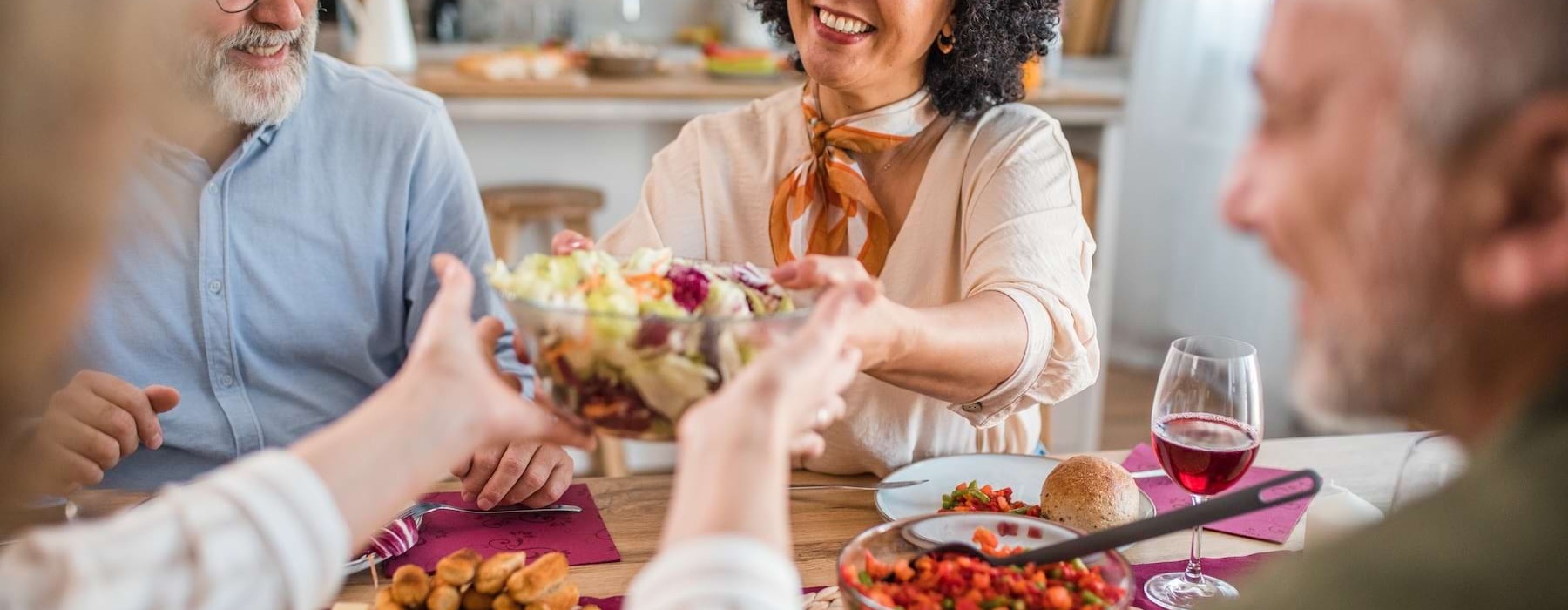 a group of people sitting around a table with food
