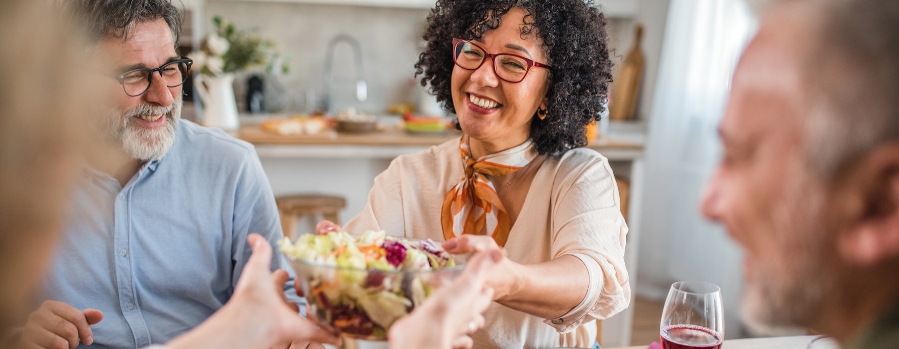 a group of people sitting around a table with food